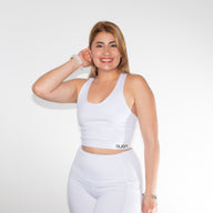 Woman in LOOK AT ME sports bra GUGA showing three-quarter angle, highlighting the flattering high-neck cut and athletic fit
