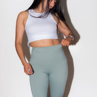 LIFT AND SCULPT yummy control leggings in black on model, side view displaying the tummy control panel and seamless waistband construction