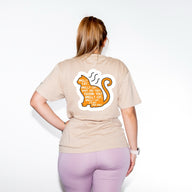 A person wearing a t-shirt with a Friends graphic and text on the front.