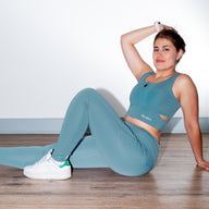 Woman wearing COMFTY high waisted leggings GUGA, athletic pose, breathable fabric